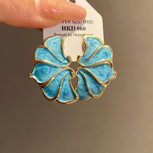 Elegant vintage blue enamel flower stud earrings with gold trim and silver needles