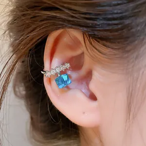 Detailed close-up showing a sparkling blue sugar cube ear cuff with cubic zirconia accents.