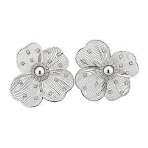 Elegant silver-toned hollow flower stud earrings with central pearl and sparkling crystals