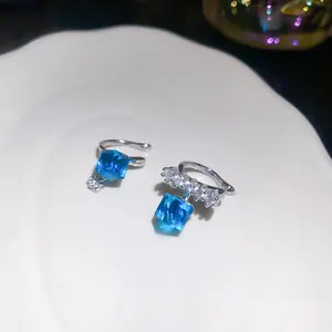 Close-up of sparkling blue cube crystal ear cuffs with clear zircon accents