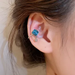 Close-up detail of a blue sugar cube zircon ear cuff showing texture and fit on ear