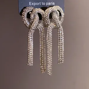 Close-up of sparkling full-diamond bow-knot tassel earrings with elegant detail