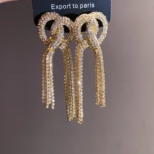 Exquisite close-up of luxurious long tassel earrings with sparkling rhinestone bow knots