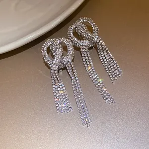 Close-up of sparkling rhinestone bow-knot tassel earrings with elegant drapes