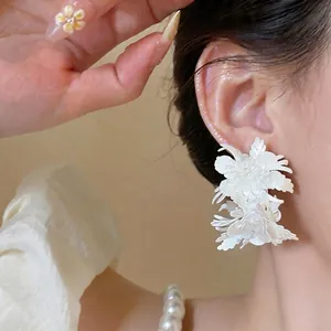 Elegant French vintage white leather flower ear studs with a unique layered floral design.