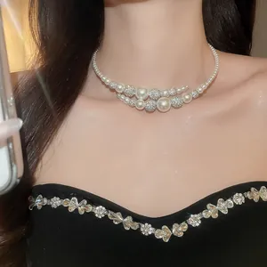 Elegant French vintage pearl choker necklace with sparkling rhinestone details on a model's neck