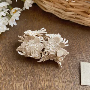 Detailed macro view of off-white leather flower stud earrings with central pearl beads.