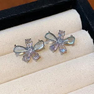 Elegant zircon flower stud earrings with teardrop petals displayed in a white jewelry box