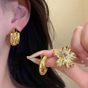 Elegant vintage gold-plated flower and thick hoop earring set shown on model for daily wear