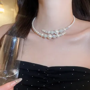 Close-up of a French vintage double-layer pearl choker with sparkling pavé balls