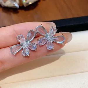 Detailed macro view of elegant zircon flower stud earrings with water drop petals