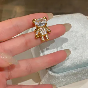 Dettaglio di un ear cuff a forma di orso placcato in oro con pietre di zircone.