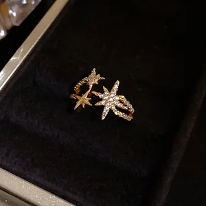 Close-up view of gold star-shaped open ring with sparkling cubic zirconia details