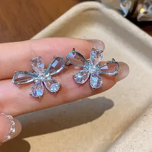 Close-up of zircon teardrop flower stud earrings showing intricate sparkle and detail