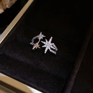 Close-up of sparkling star-shaped zircon open ring in a luxury velvet jewelry box.