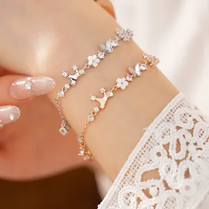 Detailed close-up of crown and butterfly bracelet with zircons and mother-of-pearl