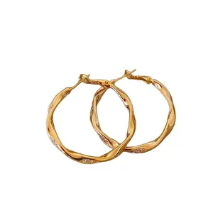 Elegant gold-plated twisted hoop earrings with micro-pave crystals for women jewelry.