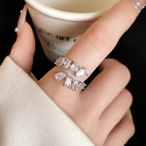 Close-up detail of a silver-toned open ring with sparkling geometric cubic zirconia stones.