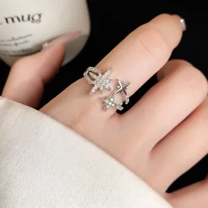 Detailed macro view of a silver-tone sparkling star zircon open ring worn on a finger