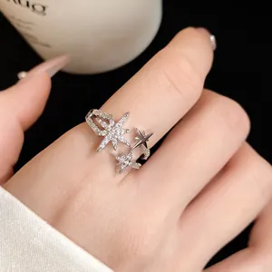 Close-up of an elegant silver-toned adjustable ring featuring sparkling star motifs.