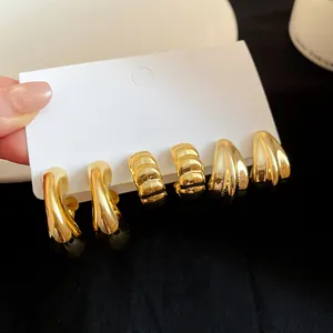 Detail view of vintage gold chunky hoop earring set on white display card