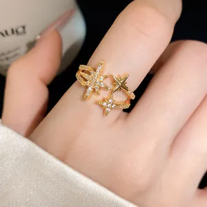 Detailed close-up of a gold-plated celestial star ring with shimmering zircon stones.