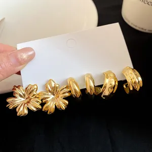 Detailed close-up view of elegant vintage gold floral and hoop earring set for women