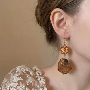 Vintage ethnic style drop earrings with decorative metal and wood elements