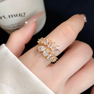 Close-up of geometric gold ring featuring multi-shaped cubic zirconia stones