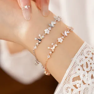 Close-up of elegant zircon and mother of pearl crown butterfly bracelets on wrist