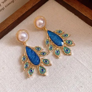 Vintage style teardrop earrings with pearls and blue enamel peacock feather motifs