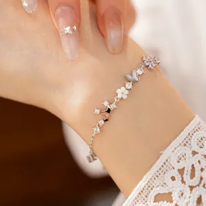 Detailed macro shot of a silver crown butterfly flower bracelet with zircon and MOP