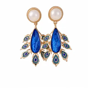 Elegant vintage gold pearl drop earrings featuring blue enamel peacock feather charms