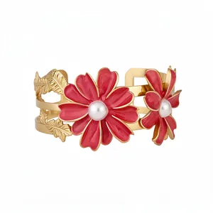 Elegant gold cuff bracelet with red enamel flowers and white pearls in a double-layer design