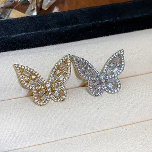Close-up detail of elegant gold and silver butterfly ear clips with cubic zirconia