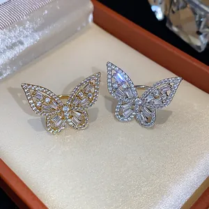 Macro view of sparkling zircon butterfly ear clips in gold and silver finishes