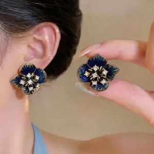 Elegant dark blue enamel flower stud earrings with sparkling crystals in gold finish