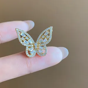 Detailed view of a sparkling gold butterfly ear cuff encrusted with shiny white zircons