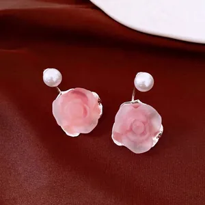 Elegant French vintage pink rose flower stud earrings with pearls on dark red velvet