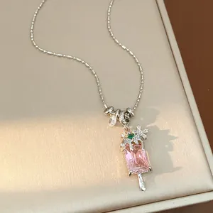 Detailed macro view of a pink zircon ice cream popsicle pendant necklace with snowflake