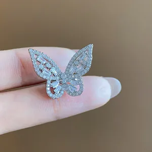 Macro detail of a sparkling silver butterfly ear cuff with micro-paved cubic zirconia