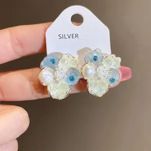 Exquisite silver needle flower stud earrings with pearls and blue zircons.