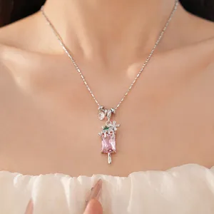 Close-up of zircon pink popsicle necklace with flower detail on Asian model.