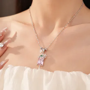 Detailed view of a pink zircon popsicle necklace with floral accents on a silver chain.
