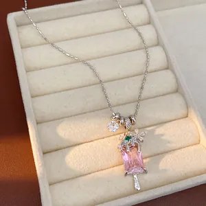 Close-up of pink zircon ice cream pendant necklace with flower detail