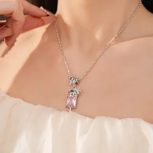 Close-up of pink zircon popsicle pendant necklace with silver flower detail on model