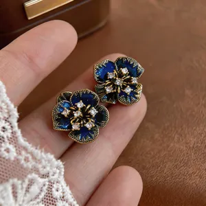 Elegant vintage dark blue flower stud earrings with crystal centers and gold textured edges