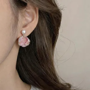 Close-up detail of French vintage pink flower stud earring with pearl inlay