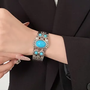 Detailed macro view of a vintage silver cuff bracelet featuring oval turquoise stones
