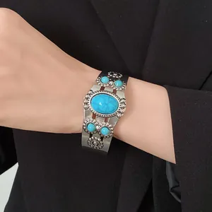 Vintage style oval turquoise flower open cuff bracelet worn on wrist for elegant styling